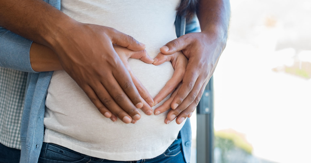 Woman and man hold her pregnant belly - Chiropractors Lake Charles LA - Dr Scott P DeRouen